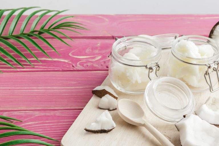 Coconut butter on wooden background. Organic healthy food concept